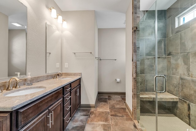 bathroom featuring a shower with door and vanity