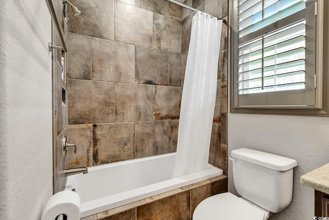 full bathroom featuring toilet, shower / tub combo with curtain, and vanity