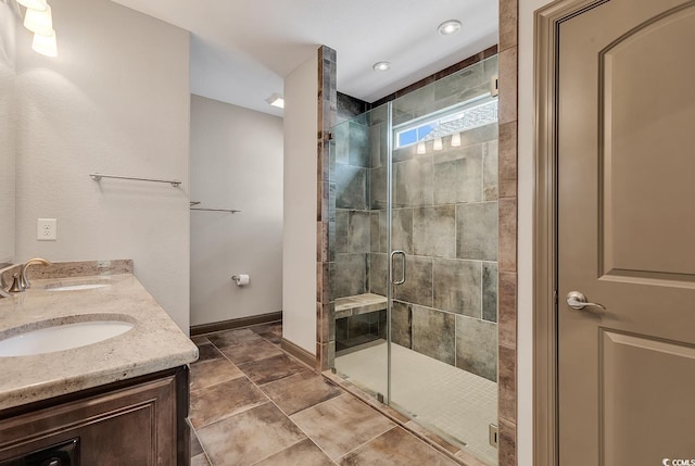 bathroom with a shower with door and vanity