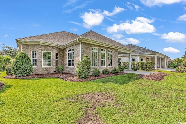 back of property with a patio area and a yard