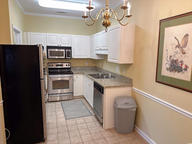 kitchen featuring white cabinets, pendant lighting, stainless steel appliances, an inviting chandelier, and ornamental molding