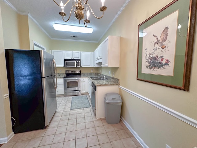 kitchen with white cabinets, a notable chandelier, stainless steel appliances, and ornamental molding