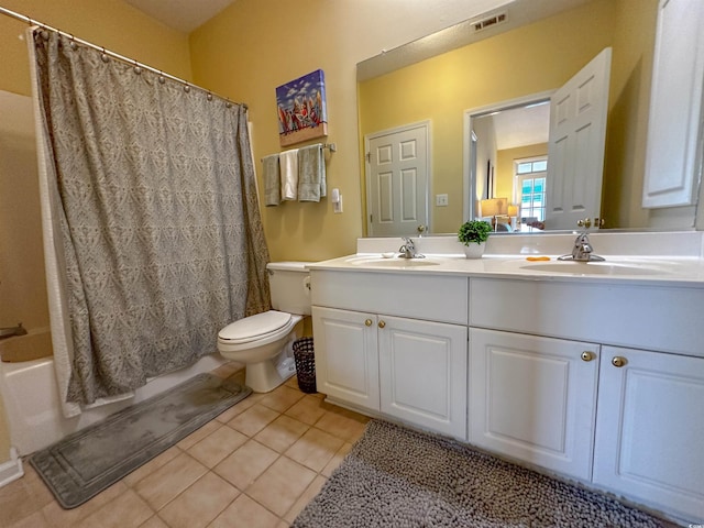 full bathroom with shower / tub combo, tile patterned flooring, vanity, and toilet