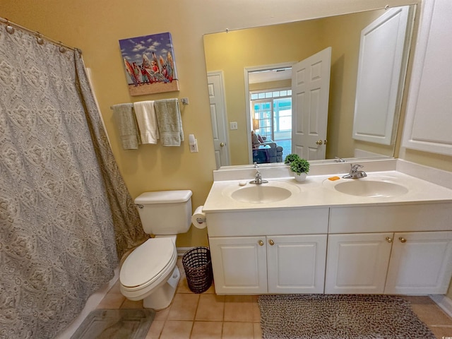 bathroom with vanity, tile patterned flooring, toilet, and curtained shower