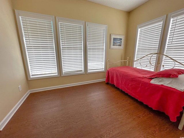 bedroom featuring a textured ceiling and dark wood-type flooring