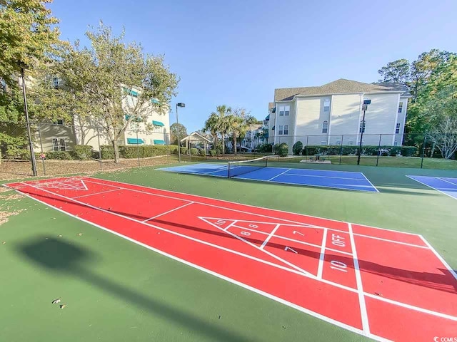 view of property's community with tennis court