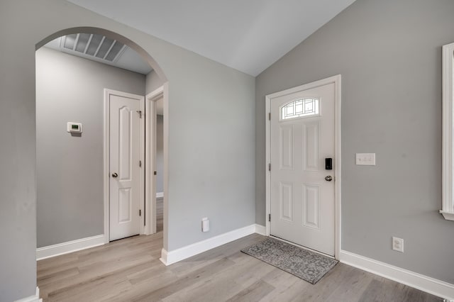 entryway featuring vaulted ceiling and light wood-type flooring