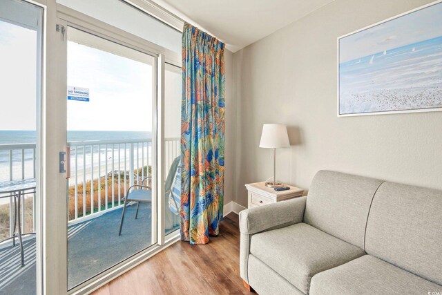 living area featuring a water view and wood-type flooring