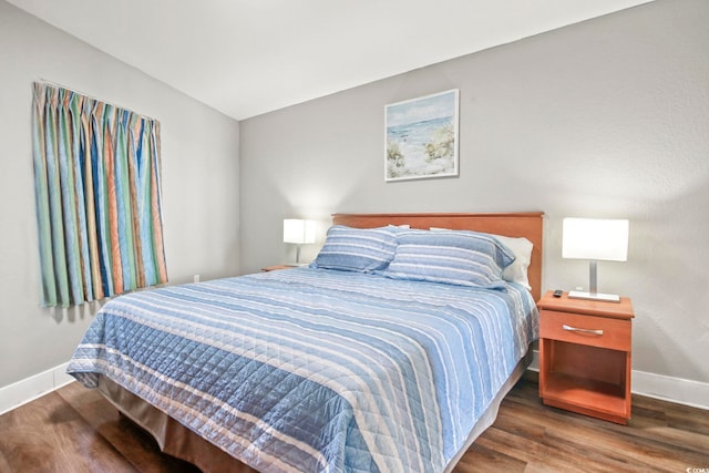 bedroom featuring baseboards and wood finished floors