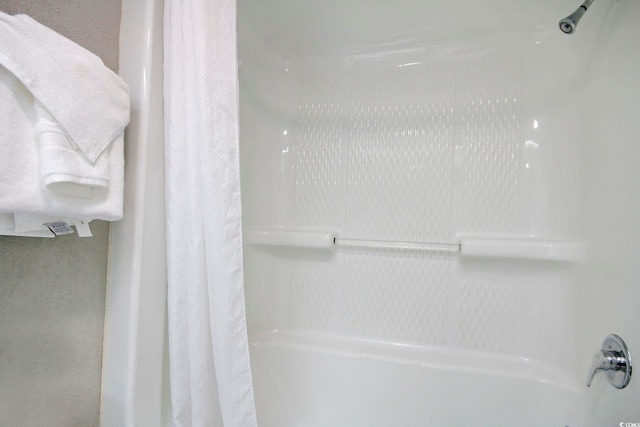 interior details featuring shower / tub combo with curtain