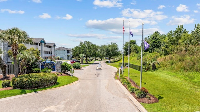 view of property's community featuring a yard