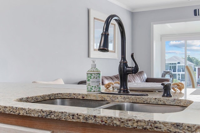 room details featuring crown molding, sink, and light stone counters