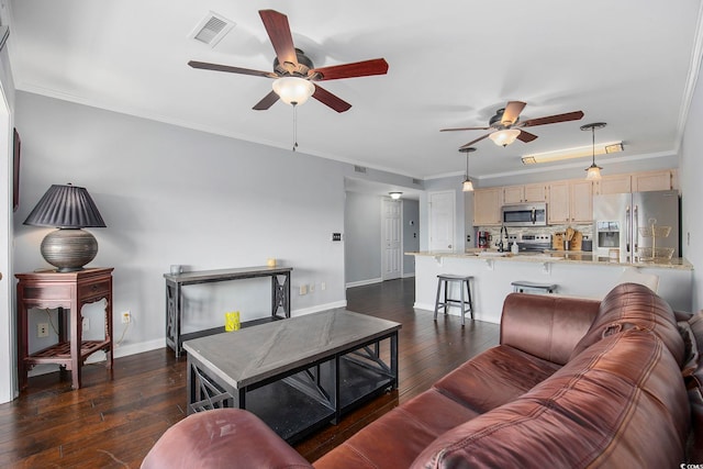 living room with dark hardwood / wood-style flooring, ornamental molding, and ceiling fan