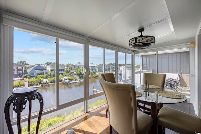 sunroom / solarium with a water view