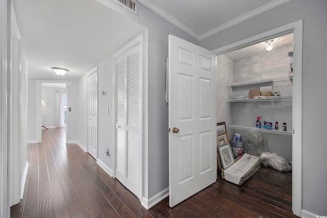 hall featuring crown molding and dark hardwood / wood-style floors