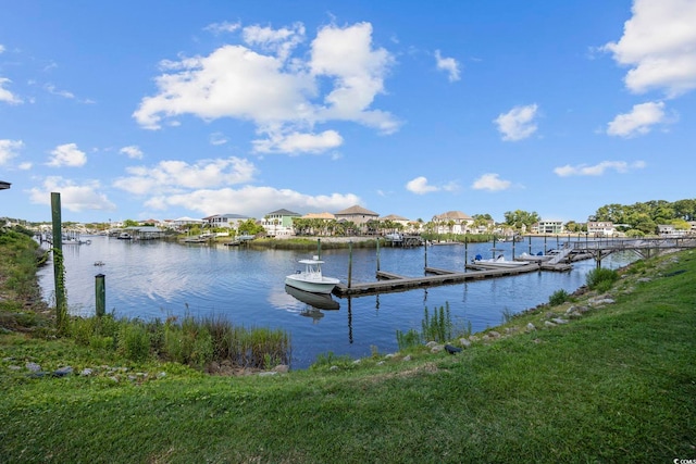 view of dock with a water view and a lawn