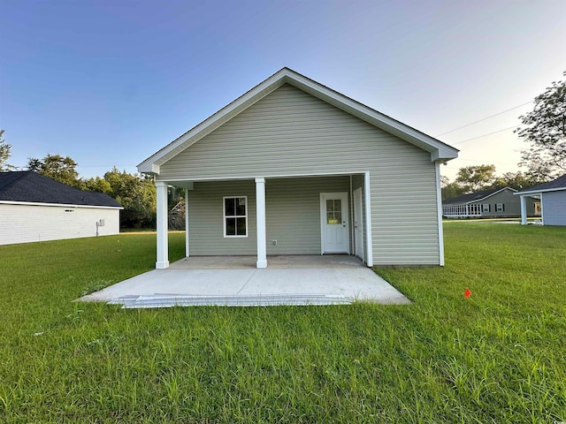 rear view of house with a yard