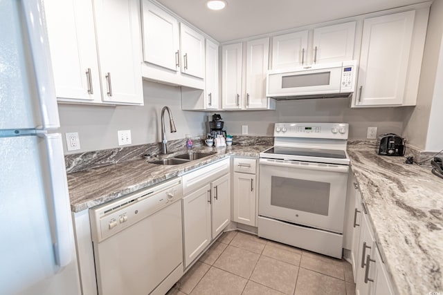 kitchen with white cabinetry, sink, white appliances, and light tile patterned floors