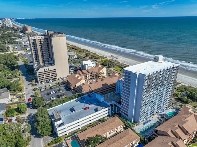 bird's eye view with a water view and a beach view