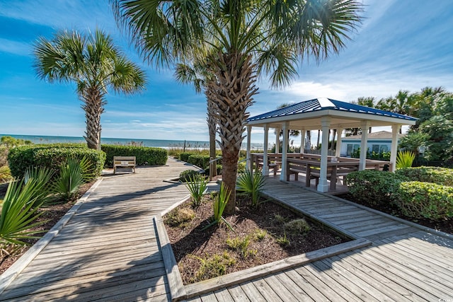 surrounding community with a gazebo and a water view