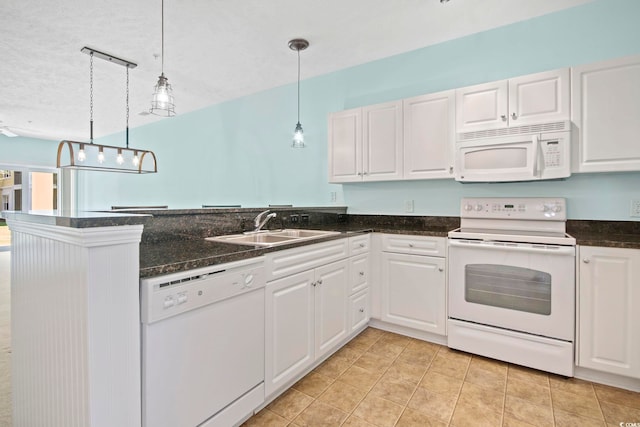 kitchen featuring kitchen peninsula, pendant lighting, white appliances, and white cabinets