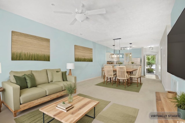 living room featuring light colored carpet and ceiling fan