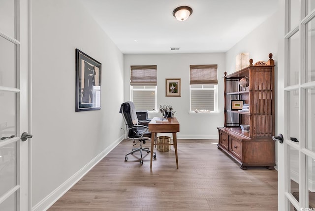 office space with french doors and light wood-type flooring