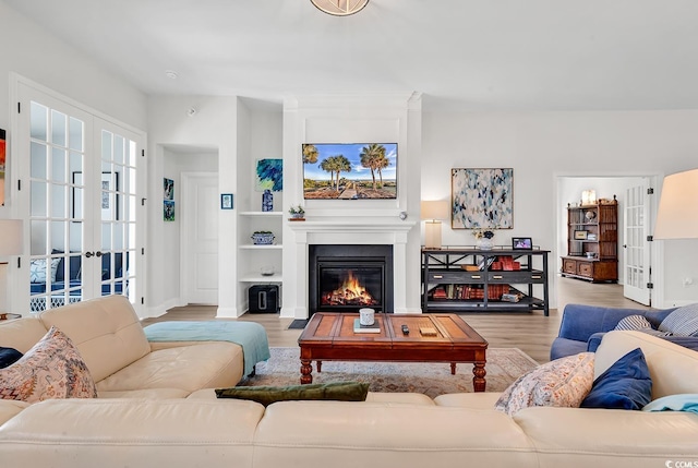 living room with light wood-type flooring and french doors