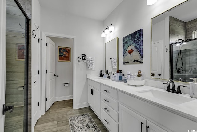 bathroom featuring vanity, wood-type flooring, and a shower with door