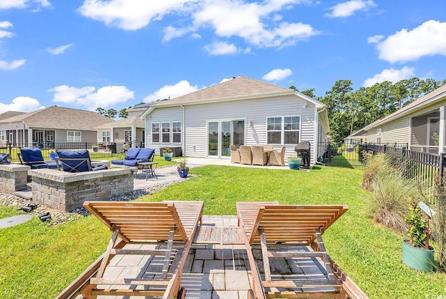 rear view of house with outdoor lounge area, a lawn, and a patio area