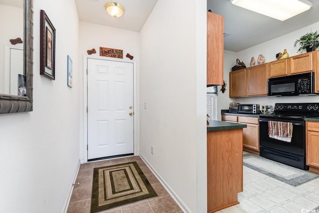 kitchen featuring light tile patterned floors and black appliances