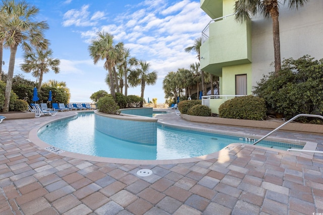 pool featuring a patio and a hot tub