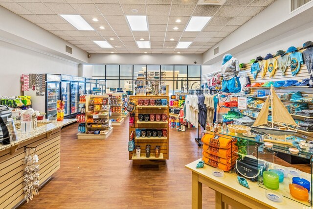 rec room featuring a drop ceiling, visible vents, and wood finished floors