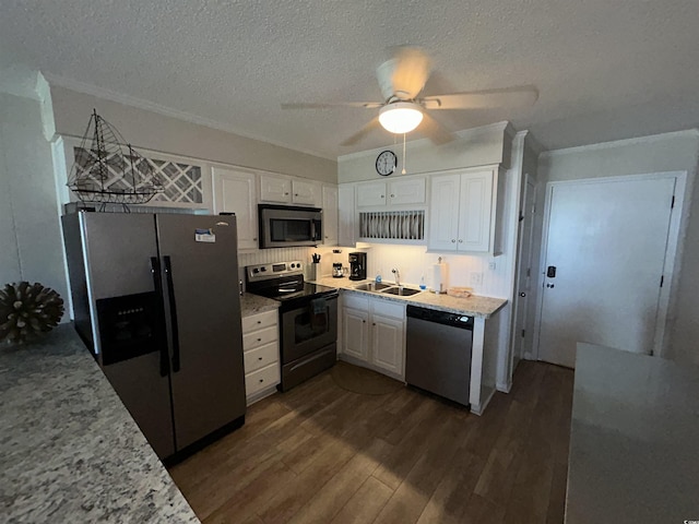 kitchen featuring sink, crown molding, stainless steel appliances, white cabinets, and dark hardwood / wood-style flooring