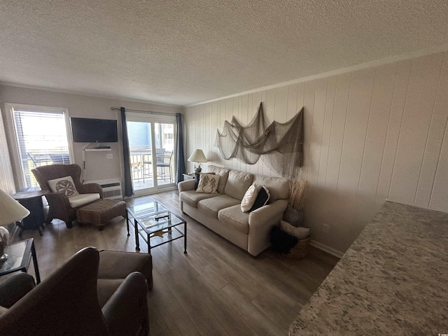 living room featuring crown molding, a wealth of natural light, a textured ceiling, and dark wood-type flooring