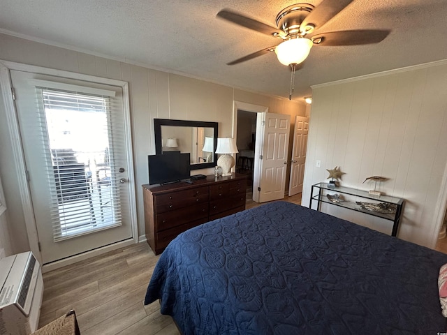 bedroom featuring ornamental molding, a textured ceiling, and light wood-type flooring