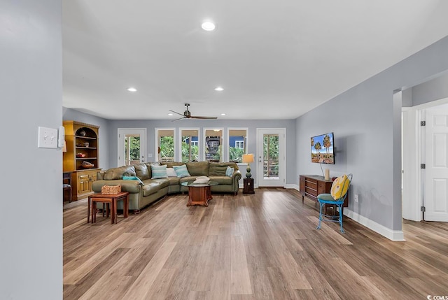 living room with hardwood / wood-style flooring and ceiling fan