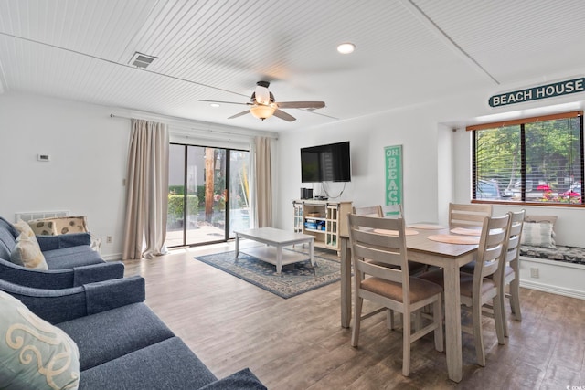 dining area with wood-type flooring, wooden ceiling, and ceiling fan