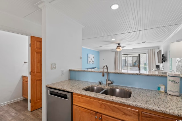 kitchen featuring light stone counters, ornamental molding, dishwasher, and sink