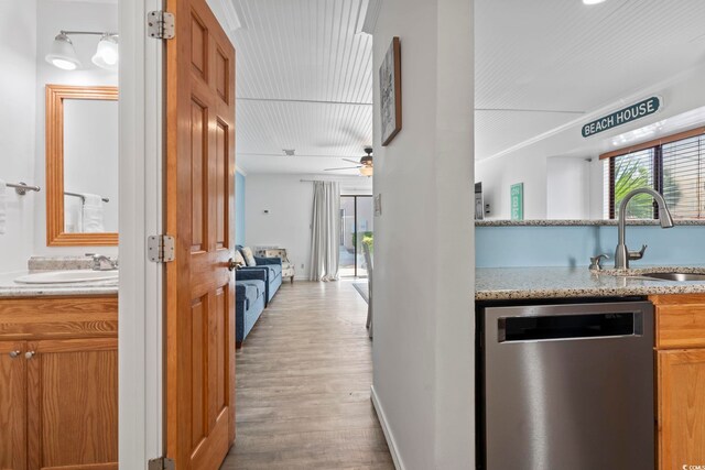 corridor featuring light hardwood / wood-style flooring and sink