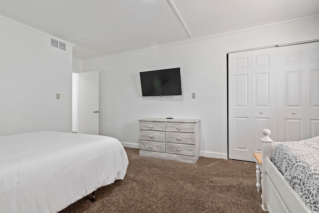 carpeted bedroom featuring ornamental molding and a closet