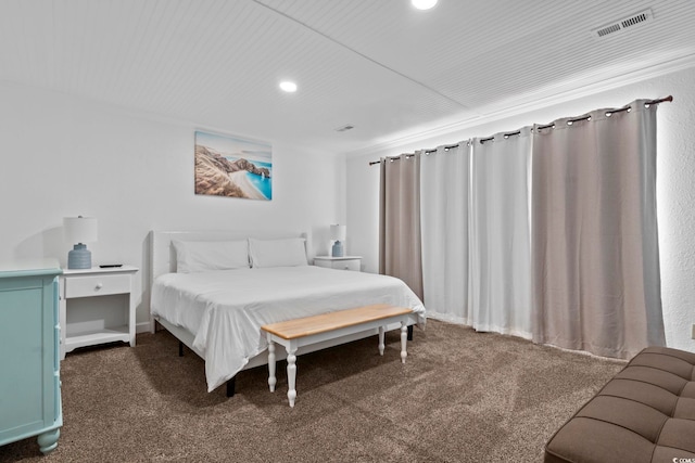 bedroom with dark colored carpet