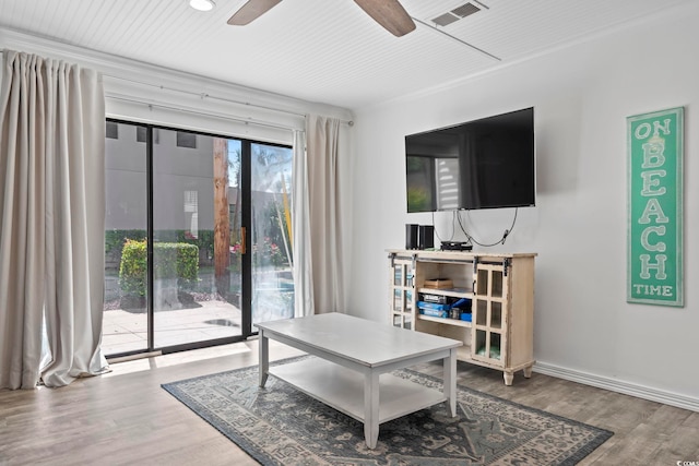 living room featuring hardwood / wood-style floors and ceiling fan