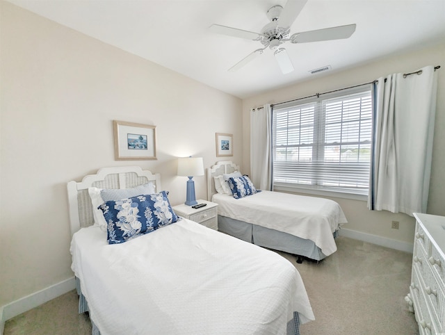 bedroom featuring ceiling fan and light carpet