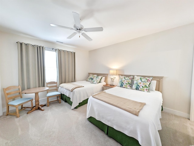 bedroom featuring light carpet and ceiling fan