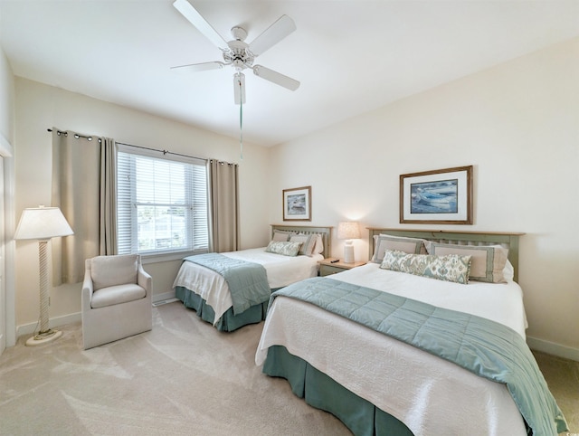 bedroom featuring light colored carpet and ceiling fan