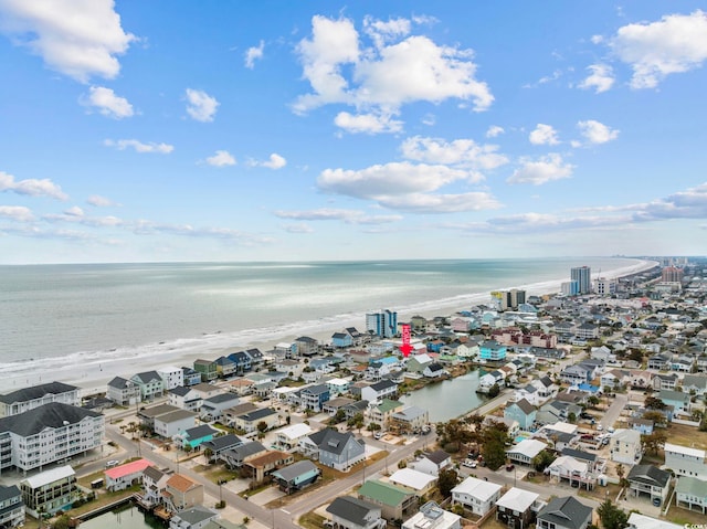 birds eye view of property with a water view and a view of the beach