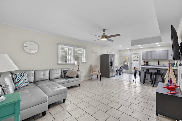 living room featuring french doors, sink, and ceiling fan