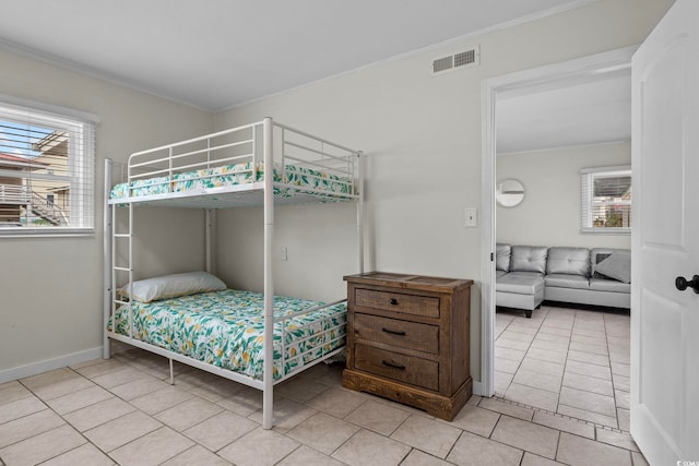 bedroom featuring ornamental molding and light tile patterned floors