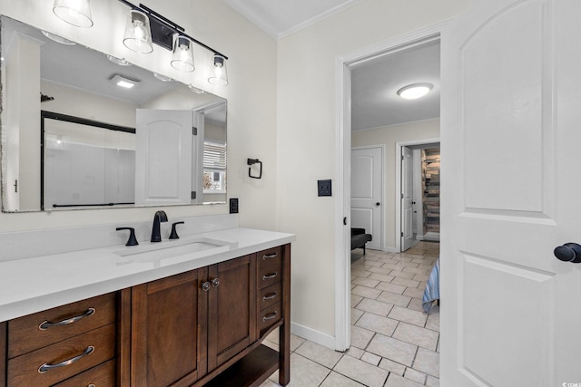 bathroom featuring tile patterned flooring, vanity, ornamental molding, and walk in shower